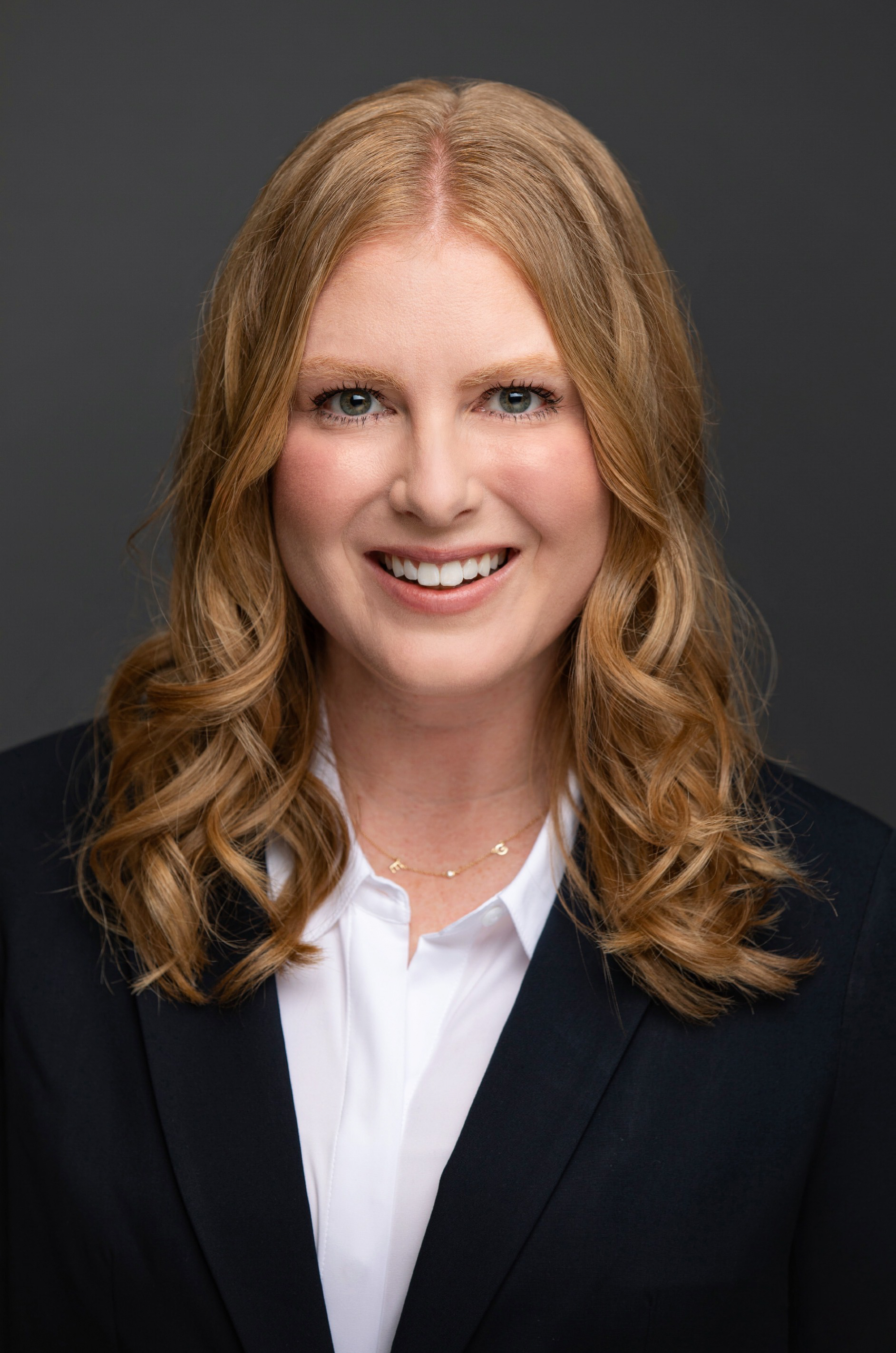 Shellena Heber is wearing a black coat over a white shirt